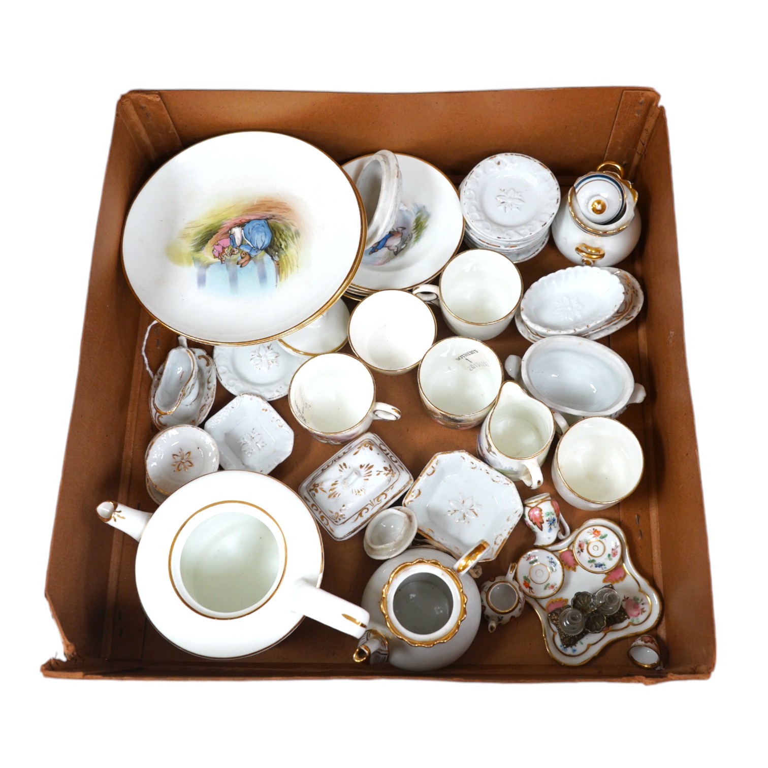 A children’s Beatrix Potter part tea set and other miniature porcelain tableware, largest 15.5cm wide. Condition - fair